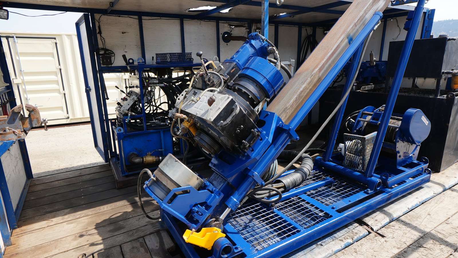 Discovery II drill head and feed frame inside the open work enclosure.