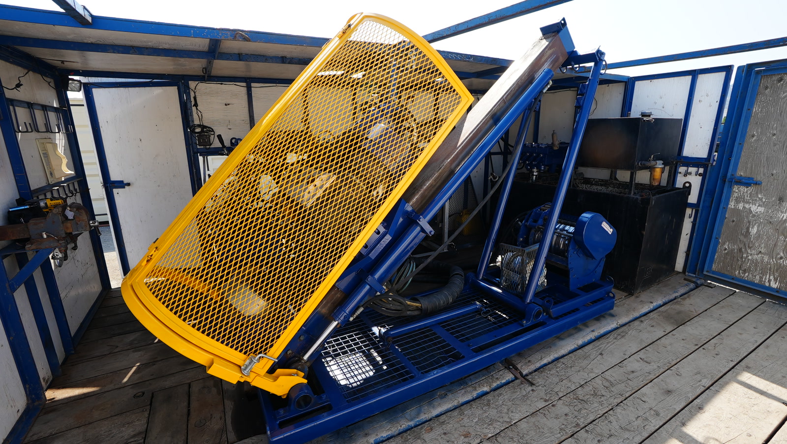 Yellow hinged safety guard over the Discovery II drill feed and working area.