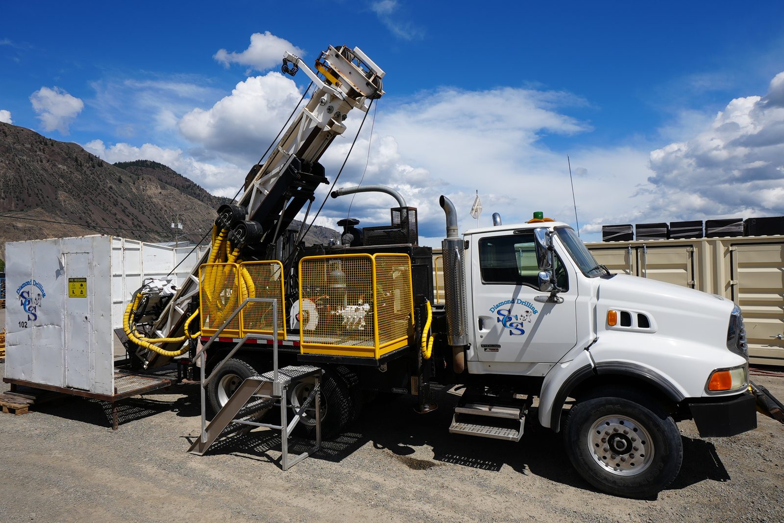 Full three-quarter view of sold LF90D Drill Unit 102 with its mast raised and doghouse attached.